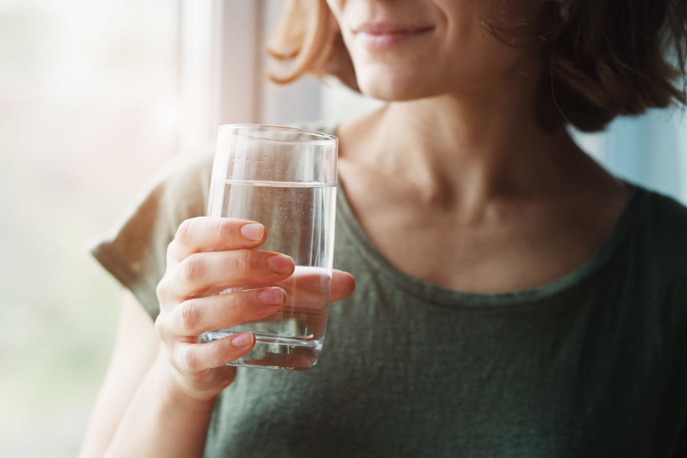 woman holding a glass of water