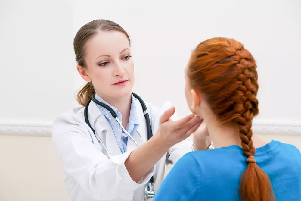 woman getting her thyroid checked