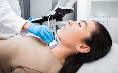 woman getting an ultrasound on her thyroid