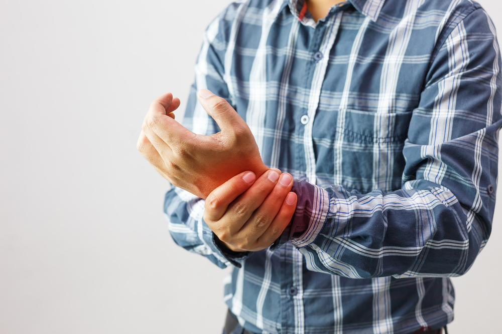 man holding wrist in pain