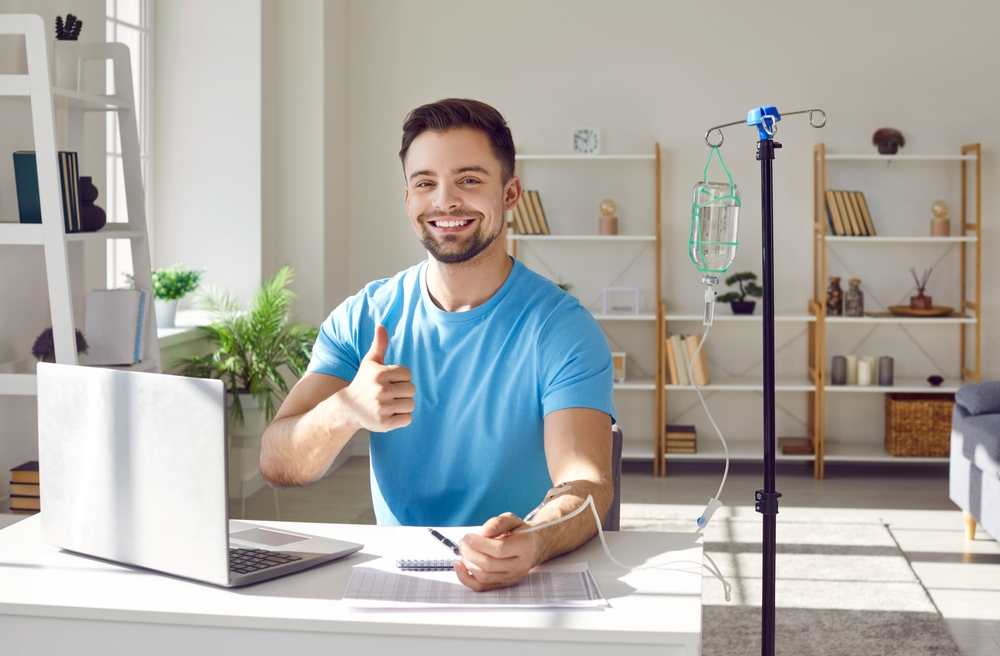 happy man receiving IV therapy