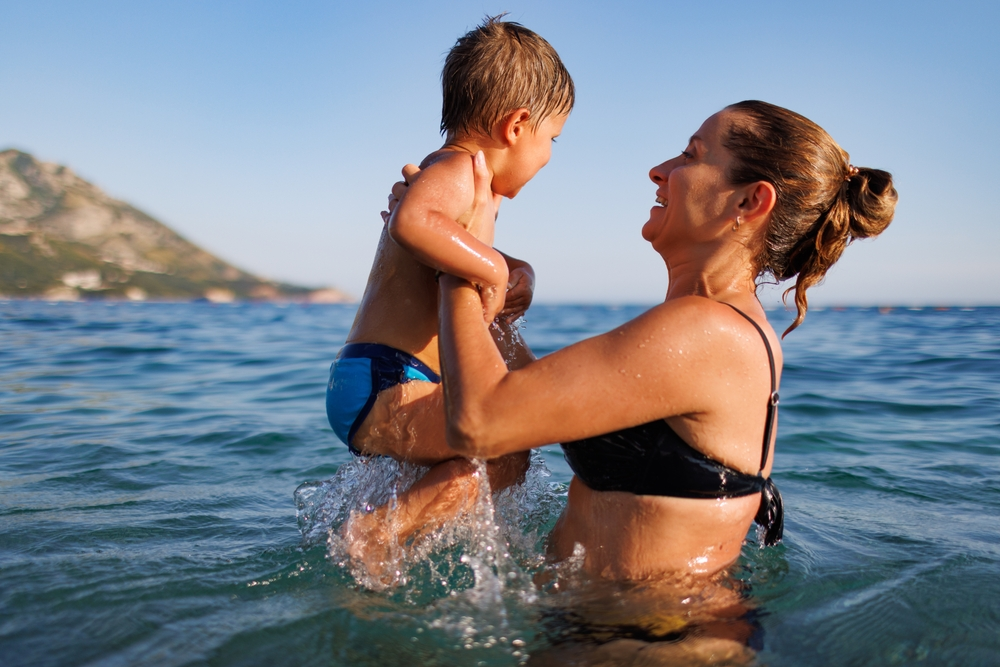 mom with child in ocean